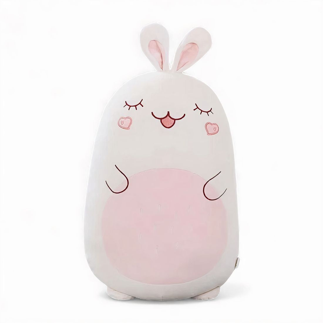 Grand coussin peluche lapin blanc et rose, avec longues oreilles, yeux fermés brodés, joues en forme de cœur et grand ventre rose, posé sur fond blanc.