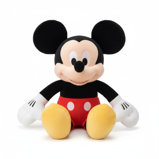 Peluche Disney Mickey iconique en short rouge et chaussures jaunes, assise, sur fond blanc.