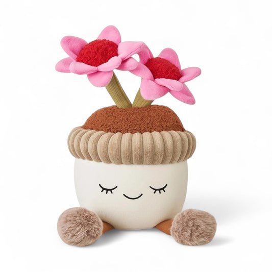 Peluche fleurs rose en pot rond style pot en terre, version kawaii  avec un visage souriant, sur fond blanc.
