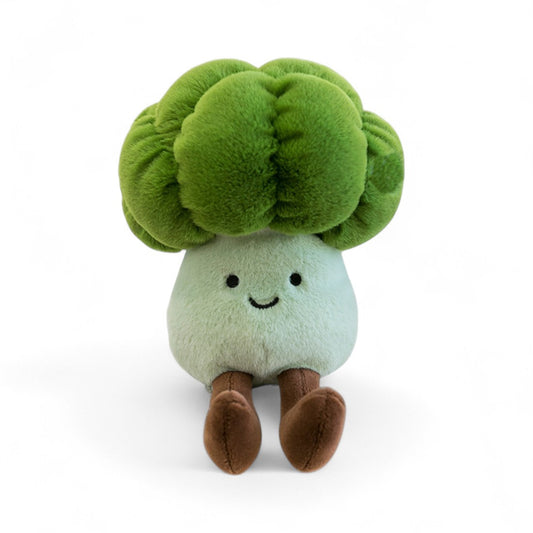 Peluche légume kawaii brocoli souriant verte et blanche de 20 cm assise avec de longues pattes marron vue de face, sur fond blanc. 