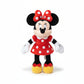 Peluche Minnie en robe rouge à pois blancs et nœud assorti, debout, sur fond blanc.
