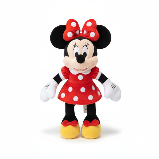 Peluche Minnie en robe rouge à pois blancs et nœud assorti, debout, sur fond blanc.