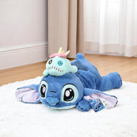 Peluche Stitch allongé avec le doudou de Lilo