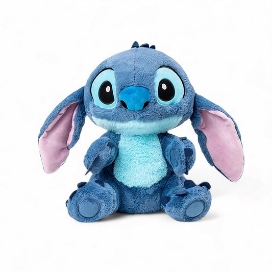 Peluche Stitch assis avec ses grandes oreilles déployées vers le bas, sur fond blanc. 