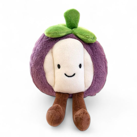 Peluche ronde en forme de mangoustan violet et blanc, avec un petit sourire, des pattes marron et une feuille verte sur la tête, posée sur fond blanc.