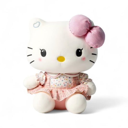 Peluche Hello Kitty en tissu coton, robe rose pastel et grand nœud rayé, posée sur fond blanc,.