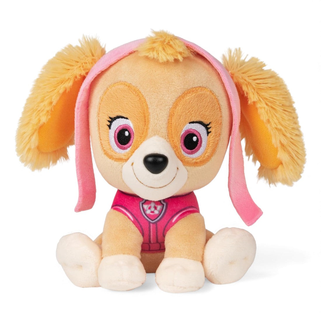 Peluche Stella avec pelage beige, oreilles duveteuses, tenue rose et lunettes roses sur la tête, souriante, posée assise sur fond blanc.