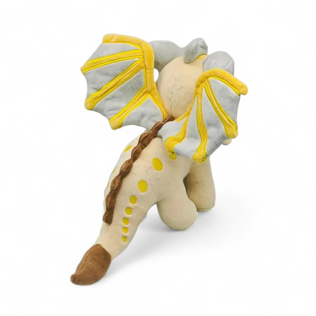 Peluche dragon féérique gris doré lumineux - vue de trois-quarts arrière, ailes déployées