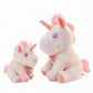 Peluche licorne pastel pour enfant avec nœud fleuri