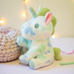 Peluche licorne pastel pour enfant avec nœud fleuri