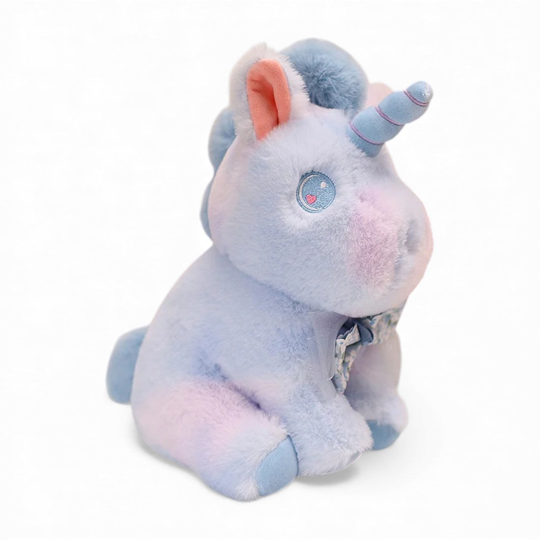 Peluche licorne pastel pour enfant avec nœud fleuri