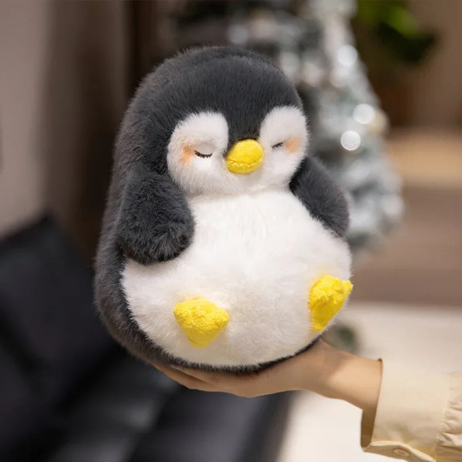 Peluche pingouin moelleux endormi