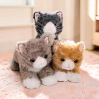 Peluche chat à câliner - trois coloris sur un tapis rose